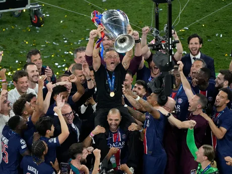 PSG's head coach Luis Enrique lifts the trophy after winning the Champions League tournament at the Allianz Arena in Munich, Germany, Saturday, May 31, 2025. (AP Photo/Michael Probst)

- XCHAMPIONSLEAGUEX