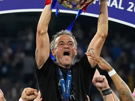 PSG's head coach Luis Enrique holds up the trophy as he celebrates with his players after winning the Champions League final soccer match between Paris Saint-Germain and Inter Milan at the Allianz Arena in Munich, Germany, Saturday, May 31, 2025. (AP Photo/Martin Meissner)

- XCHAMPIONSLEAGUEX