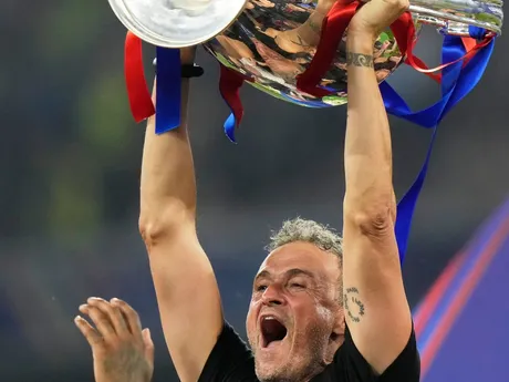PSG's head coach Luis Enrique holds the trophy after winning the Champions League final soccer match between Paris Saint-Germain and Inter Milan at the Allianz Arena in Munich, Germany, Saturday, May 31, 2025. (AP Photo/Luca Bruno)

- XCHAMPIONSLEAGUEX