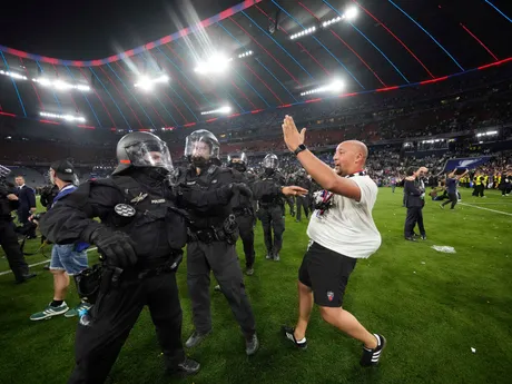 Police block PSG supporters invading the pitch at the end of the Champions League final soccer match between Paris Saint-Germain and Inter Milan at the Allianz Arena in Munich, Germany, Saturday, May 31, 2025. (AP Photo/Luca Bruno)

- XCHAMPIONSLEAGUEX