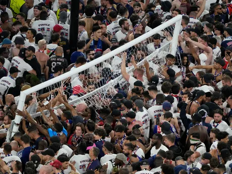 Fans of PSG invade the pitch after the Champions League final soccer match between Paris Saint-Germain and Inter Milan at the Allianz Arena in Munich, Germany, Saturday, May 31, 2025. (AP Photo/Michael Probst)

- XCHAMPIONSLEAGUEX