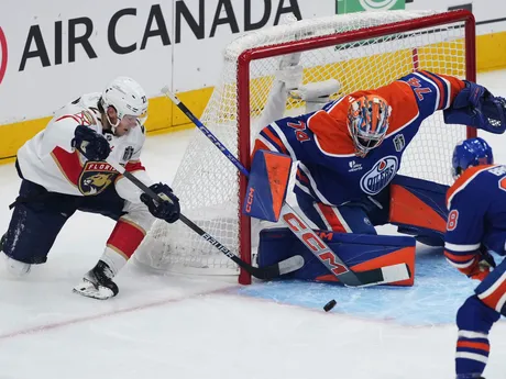 Florida Panthers' Eetu Luostarinen, left, is stopped by Edmonton Oilers goalie Stuart Skinner during the first period in Game 1 of the NHL hockey Stanley Cup Finals, in Edmonton, Alberta, on Wednesday, June 4, 2025. (Darryl Dyck/The Canadian Press via AP)